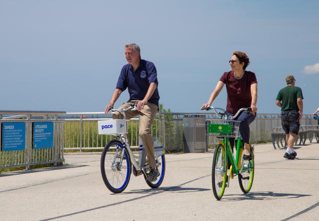 Mayor Bill de Blasio and DOT Commissioner Trottenberg trying the dockless bikes in the Rockaways, last summer. 