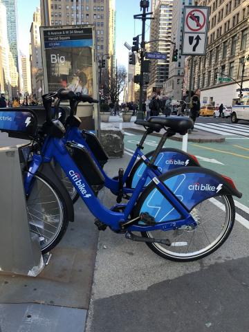 Two electric bikes at a station in midtown