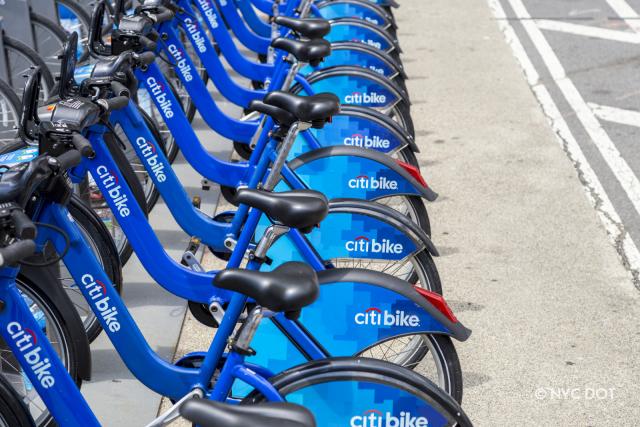 A row of Citi Bikes parked at a station