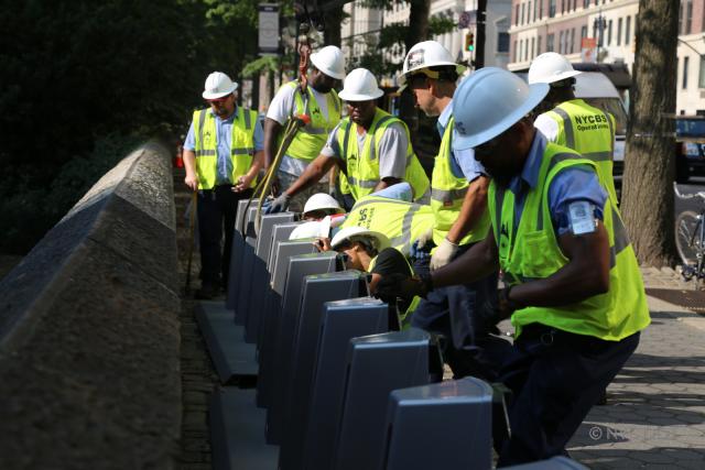 A photo of Citi Bike workers installing a station in the Upper East Side. 