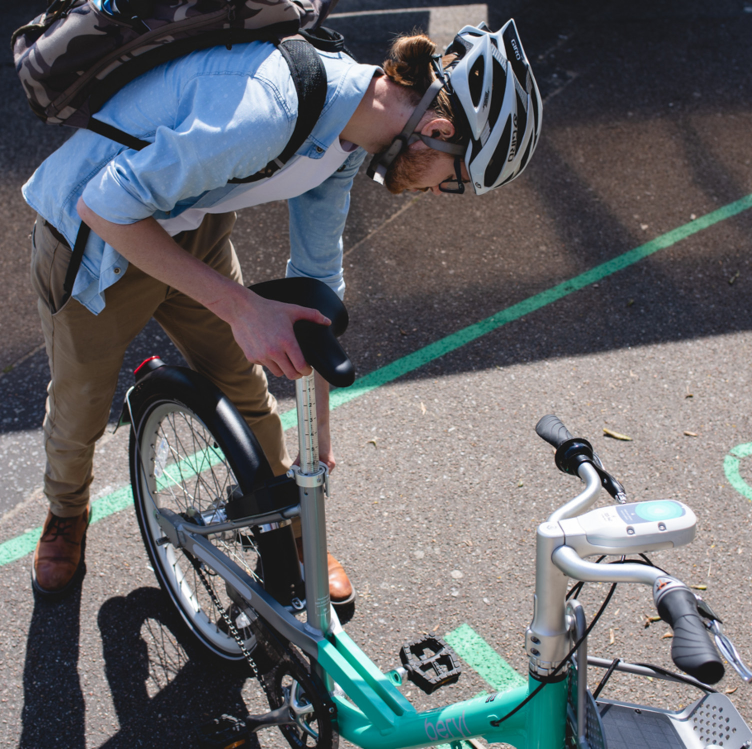 A person unlocking a bike inside of a Beryl Bay