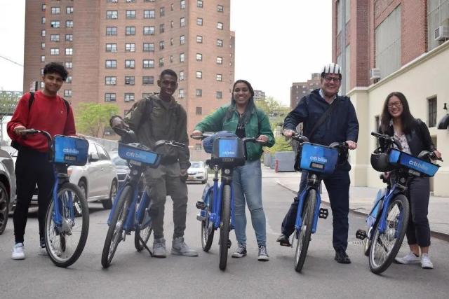 A group of 4 younger people on Citi Bikes.