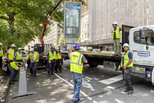 Citi Bike crew installs new Citi Bike station using crane