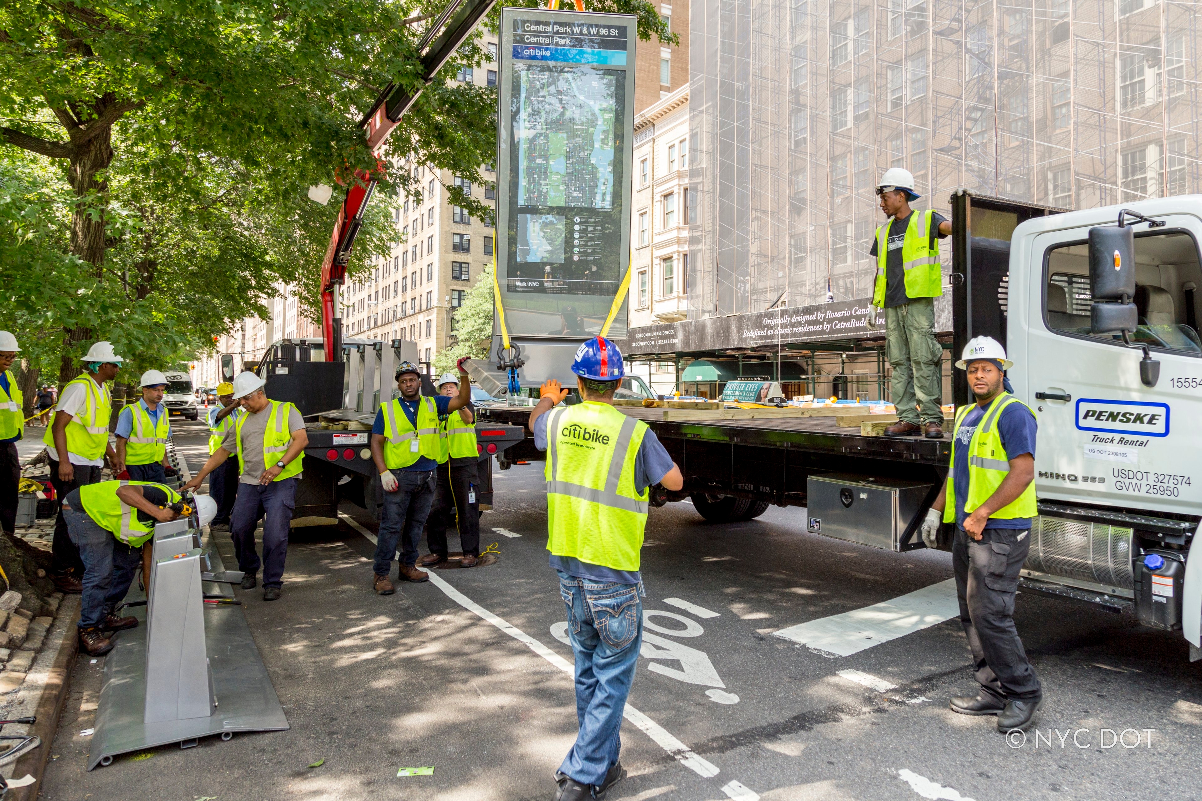 Citi Bike crew installs new Citi Bike station using crane