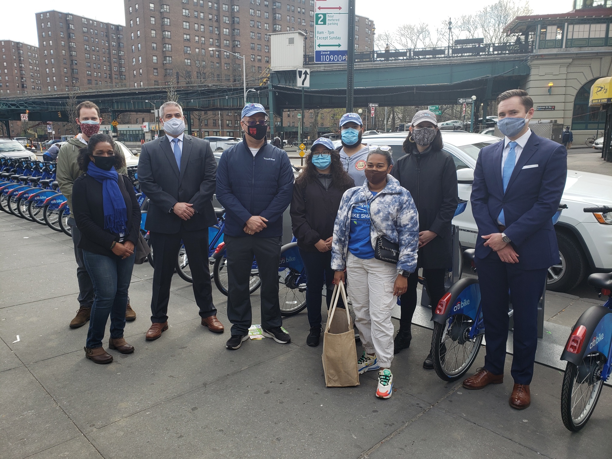 A photo of Commissioner ED Pincar with Lyft officials in front of a Citi Bike station. 