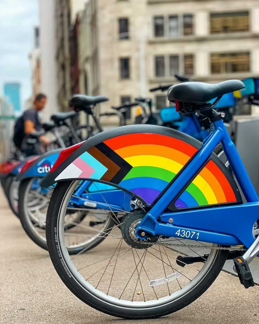 A Citi Bike with a PRIDE logo on the rear fender